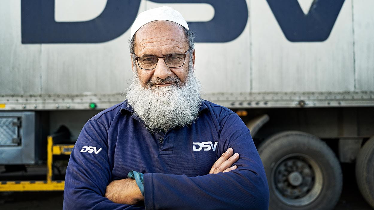 Staff from the KSA DSV in front of a DSV transport truck.